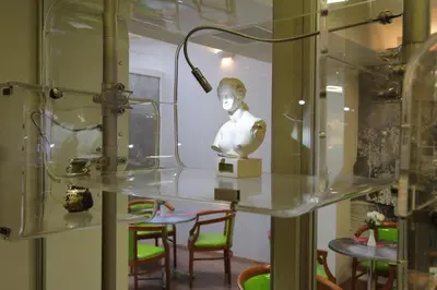 a bust of a woman in a glass display case at Attalos Hotel in Athens
