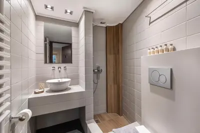 a bathroom with a sink and a shower at Genesis Grande Acropolis Hill Villa in Athens