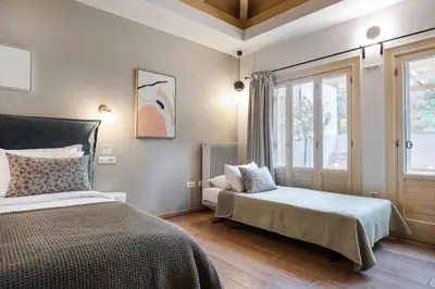 a bedroom with two beds and a window at Genesis Grande Acropolis Hill Villa in Athens