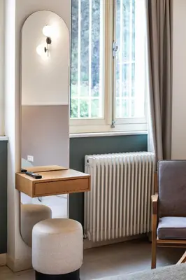 a room with a desk and a radiator and a chair at Genesis Grande Acropolis Hill Villa in Athens