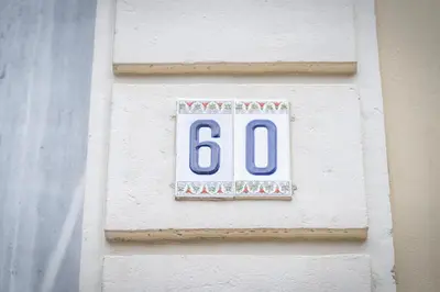 a sign on a wall with the number at Genesis Grande Acropolis Hill Villa in Athens