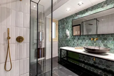 a bathroom with a sink and a glass shower at Genesis Grande Acropolis Hill Villa in Athens