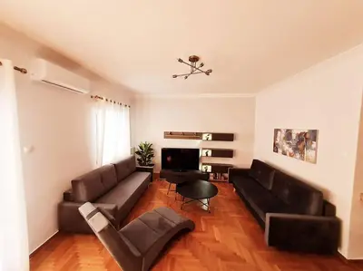 a living room with a couch and a fireplace at Lovely 2-Bedroom 4th Floor House Large Patio in Athens