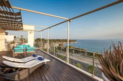 a balcony with a view of the ocean at Tropical Hotel in Athens
