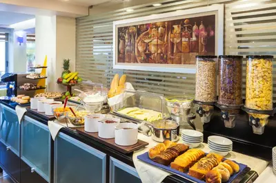 a buffet line with many food items on it at Tropical Hotel in Athens