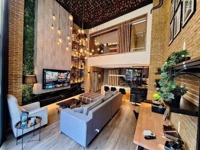 a living room with a couch and a table at The Athens Loft with private gym and billiards in Athens