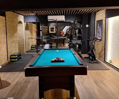 a pool table in a room with a gym at The Athens Loft with private gym and billiards in Athens