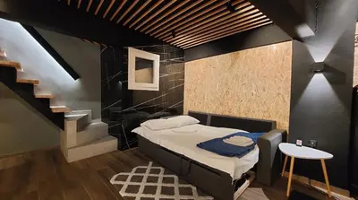 a small room with a bed and a staircase at The Athens Loft with private gym and billiards in Athens