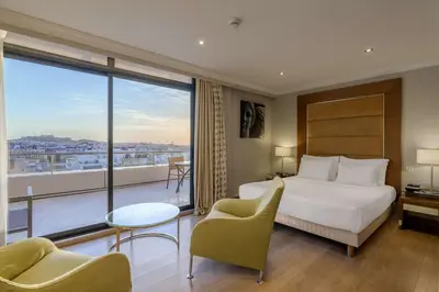 a hotel room with a bed and a large window at Radisson Blu Park Hotel Athens in Athens