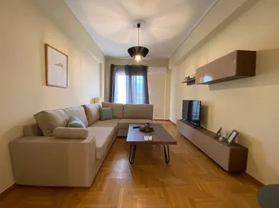 a living room with a couch and a table at Spacious 3 BR Apartment in Vibrant Neighbourhood in Athens