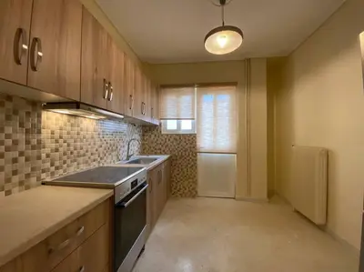 a kitchen with a sink and a stove top oven at Spacious 3 BR Apartment in Vibrant Neighbourhood in Athens