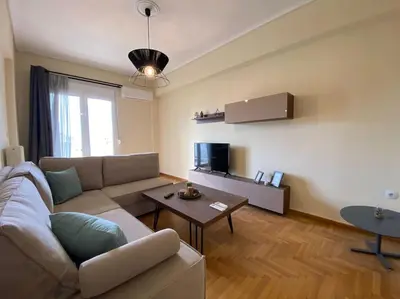 a living room with a couch and a table at Spacious 3 BR Apartment in Vibrant Neighbourhood in Athens