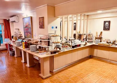 a kitchen with a counter with a lot of food at Triton Hotel Piraeus in Piraeus
