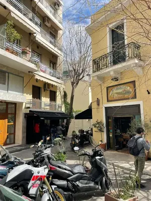 a group of motorcycles parked in front of a building at Acropolis selected apartment in Athens
