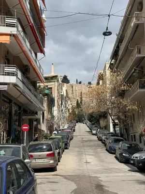 a street with cars parked on the side of the road at Acropolis selected apartment in Athens