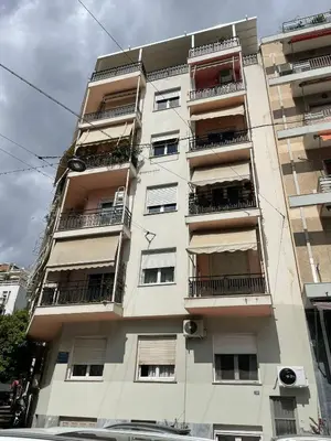 a tall white building with balconies on it at Acropolis selected apartment in Athens