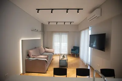 a living room with a couch and a tv at Acropolis Vibes Apartments in Athens