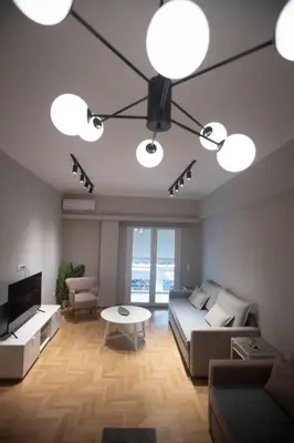a living room with a couch and a table at Acropolis Vibes Apartments in Athens