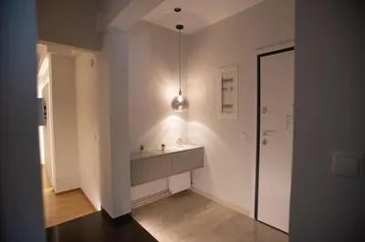 a white bathroom with a sink and a mirror at Acropolis Vibes Apartments in Athens