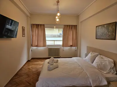 a bedroom with a bed with two stuffed animals on it at F23 in Athens