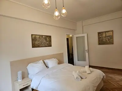 a bedroom with a white bed with two towels on it at F23 in Athens