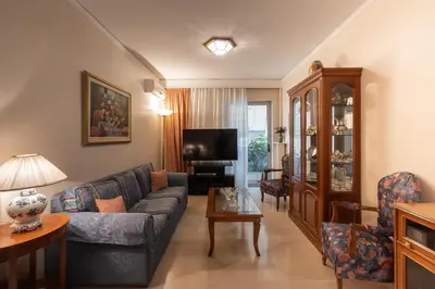 a living room with a couch and a tv at 2 BR Apartment 5 minutes to Thissio Metro & Acropolis in Athens