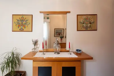 a room with a table with two candles on it at 2 BR Apartment 5 minutes to Thissio Metro & Acropolis in Athens