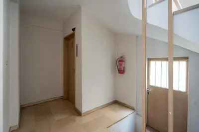 an empty hallway with a fire hydrant on the wall at 2 BR Apartment 5 minutes to Thissio Metro & Acropolis in Athens