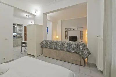 a bedroom with a bed and a large mirror at Mavili Square Cozy Apt AC & Kitchen, near Metro in Athens