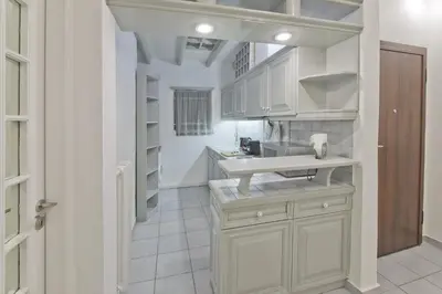 a kitchen with white cabinets and a sink at Mavili Square Cozy Apt AC & Kitchen, near Metro in Athens