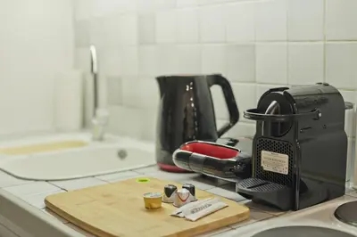 a kitchen counter with a toaster and a cutting board at Mavili Square Cozy Apt AC & Kitchen, near Metro in Athens