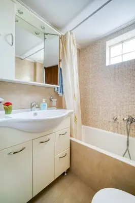 a bathroom with a sink and a bath tub at Escape with Style in this Chic 2BR Apartment! in Athens