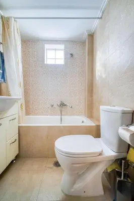a bathroom with a toilet and a bath tub at Escape with Style in this Chic 2BR Apartment! in Athens