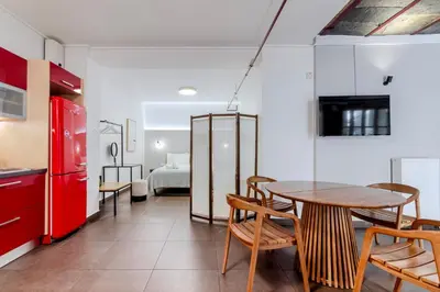 a room with a table and chairs and a bed at Filopapou Pearl on Acropolis Hill in Athens