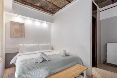 a bedroom with a bed with towels on it at Filopapou Pearl on Acropolis Hill in Athens
