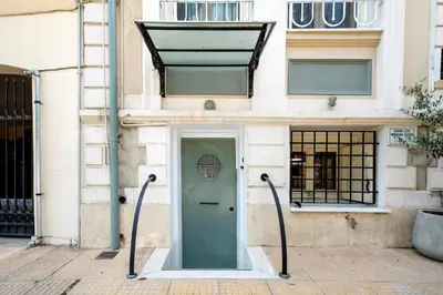 a building with a green door on a street at Filopapou Pearl on Acropolis Hill in Athens