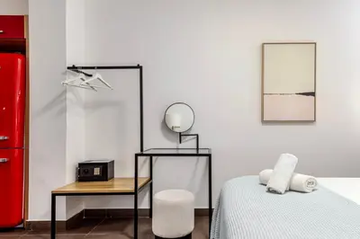 a bedroom with a bed and a mirror and a table at Filopapou Pearl on Acropolis Hill in Athens