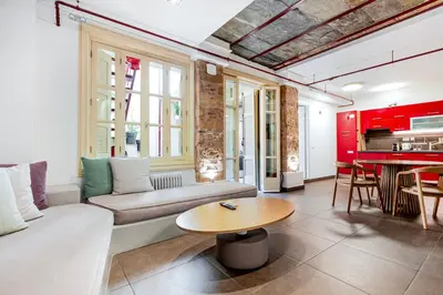 a living room with a couch and a table at Filopapou Pearl on Acropolis Hill in Athens
