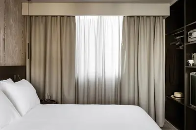 a bedroom with two beds and a window at Alassia Hotel in Athens