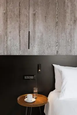 a table next to a bed with a cup and a glass at Alassia Hotel in Athens
