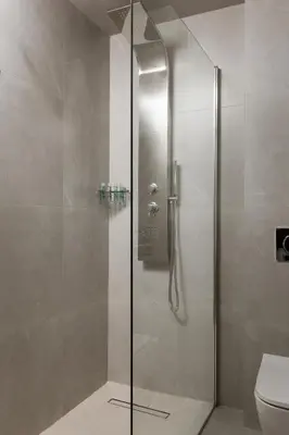 a shower with a glass door in a bathroom at Alassia Hotel in Athens
