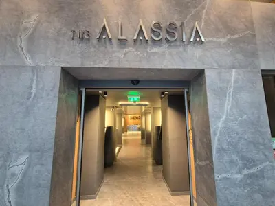 a building with a sign that reads the alaska at Alassia Hotel in Athens