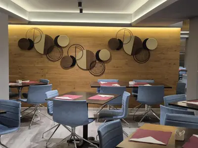 a restaurant with tables and chairs and hats on the wall at Alassia Hotel in Athens