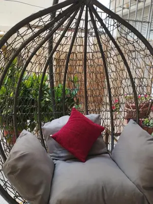a circular bed with a red pillow on it at Renovated Basement Duplex with Patio and Folk Decor in the Heart of Athens in Athens
