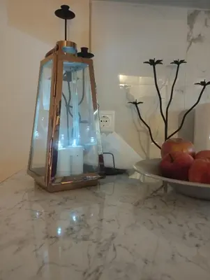 a lantern sitting on a counter with a plate of fruit at Renovated Basement Duplex with Patio and Folk Decor in the Heart of Athens in Athens
