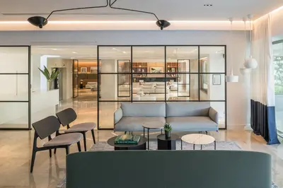 a living room with a couch and chairs at Amarilia Hotel in Athens