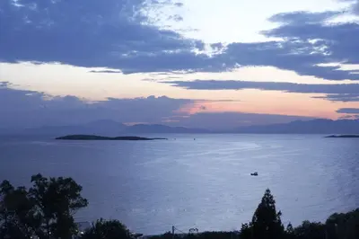 a sunset over a large body of water at Amarilia Hotel in Athens