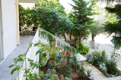 a porch with flowers and a white railing at Sunny and minimal apt in Glyfada with 3 bdrm in Athens