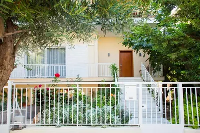 a white fence in front of a house at Sunny and minimal apt in Glyfada with 3 bdrm in Athens