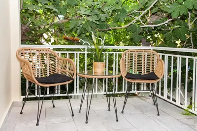 two chairs and a table on a balcony at Sunny and minimal apt in Glyfada with 3 bdrm in Athens